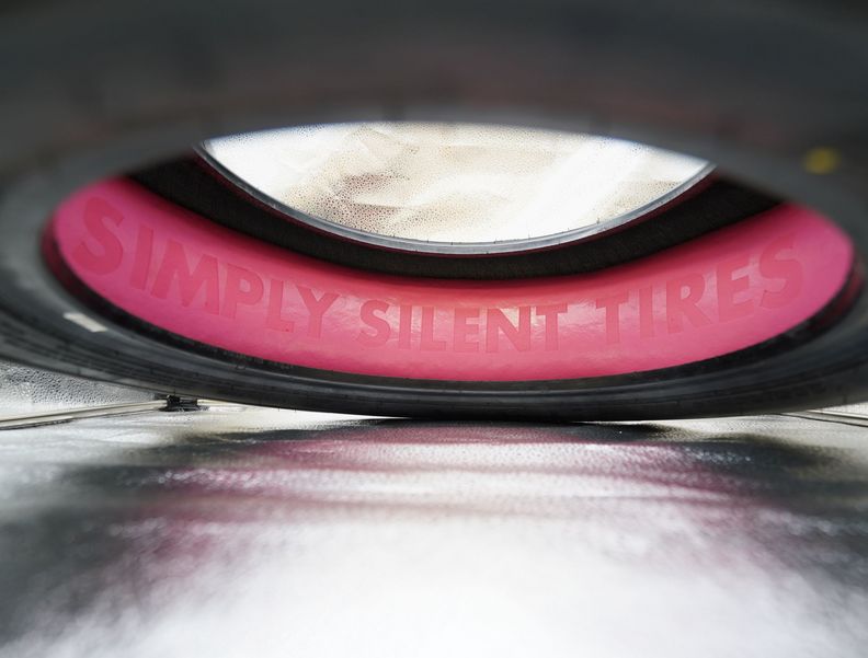 Photo of a tire with pink acoustic foam on the inside. “Simply Silent Tire” has been engraved into the surface of the foam.