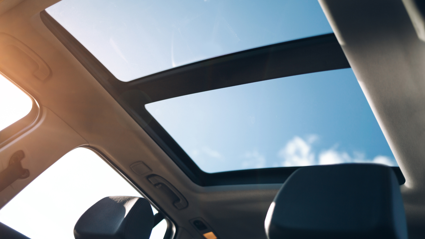 Photo of an automotive panoramic roof, taken from inside the vehicle.