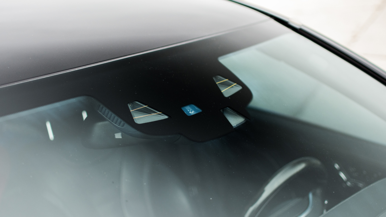 Photo of a windscreen. The focus is on the sensor area exposed from the coating.