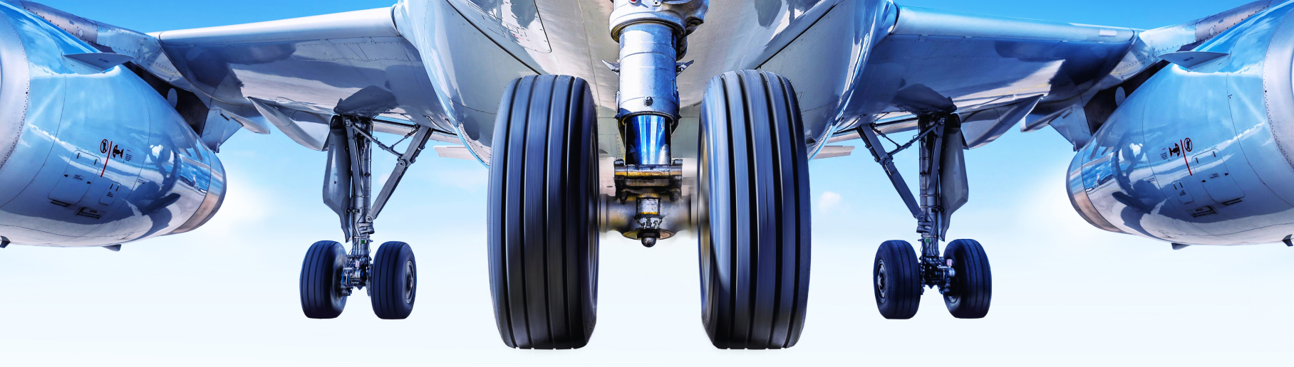 Photo of the underside of an airplane taking off.